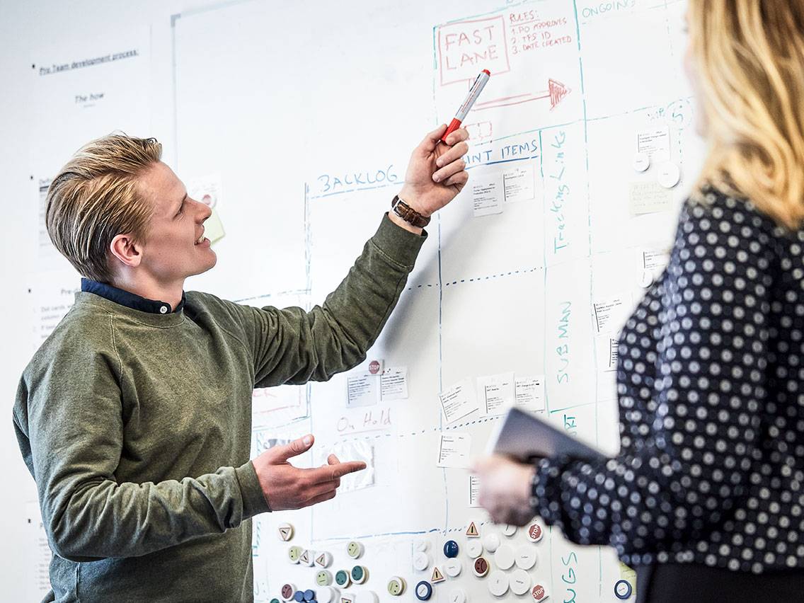 Consultant pointing on whiteboard