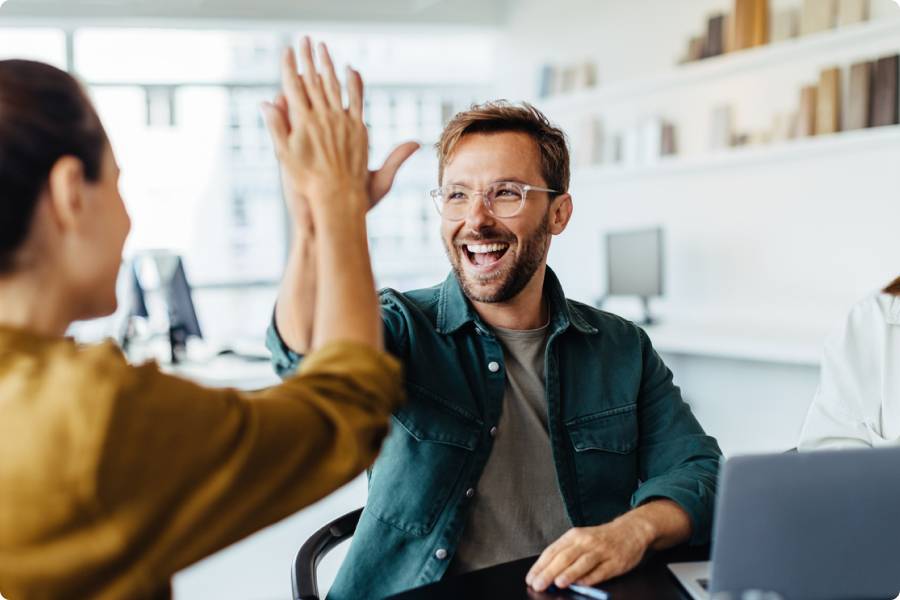 2 people look happy and does high-five.